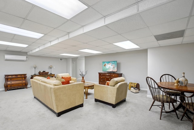 carpeted living room with an AC wall unit and a drop ceiling