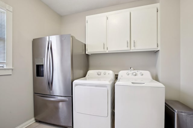 laundry area featuring cabinets and washing machine and clothes dryer