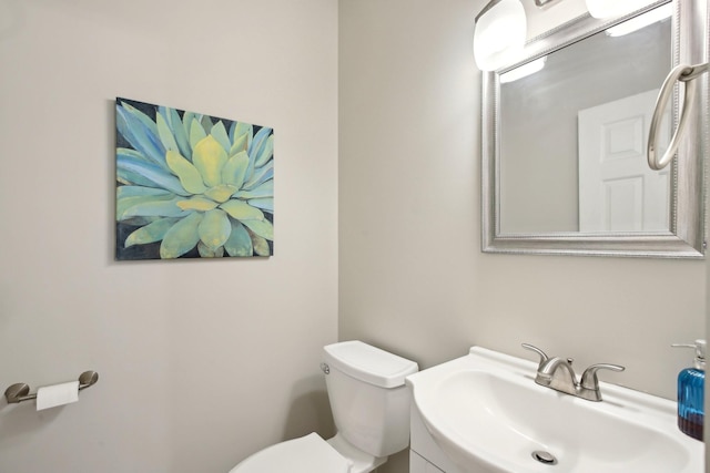 bathroom with toilet and vanity