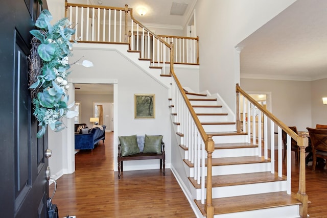 entrance foyer with hardwood / wood-style flooring and ornamental molding