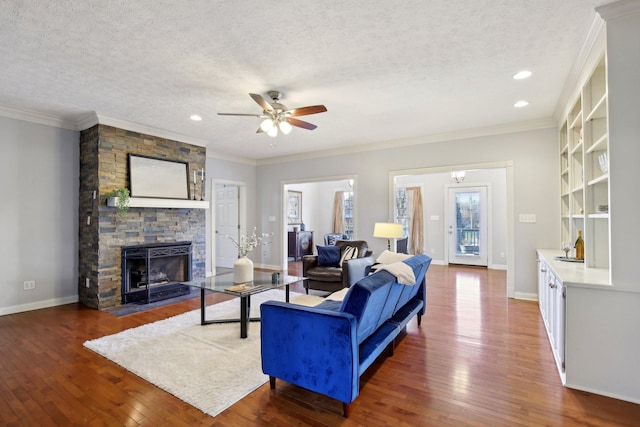 living room featuring a textured ceiling, ceiling fan, crown molding, and dark hardwood / wood-style floors