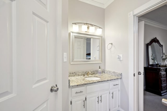 bathroom featuring ornamental molding and vanity