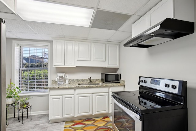 kitchen with sink, electric stove, a paneled ceiling, and white cabinetry