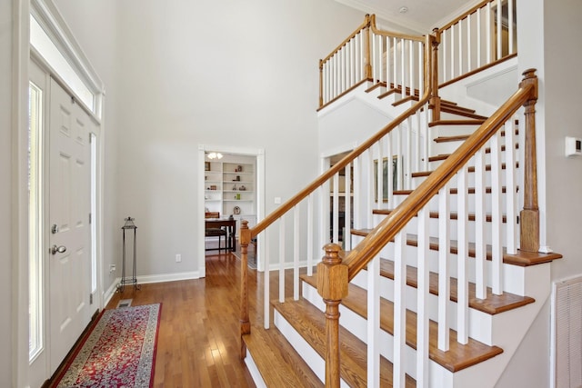 foyer entrance with a high ceiling and hardwood / wood-style floors