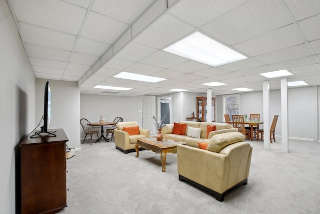 carpeted living room featuring a paneled ceiling