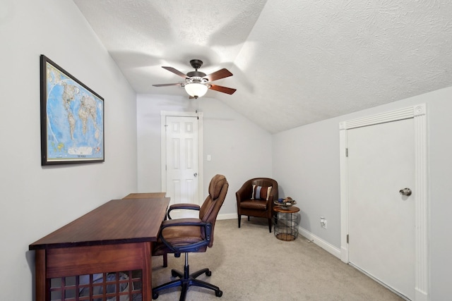 office area featuring a textured ceiling, ceiling fan, vaulted ceiling, and light colored carpet