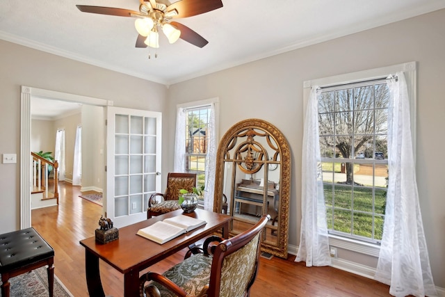 office space featuring ceiling fan, crown molding, hardwood / wood-style floors, and a wealth of natural light