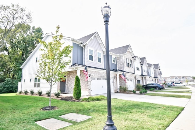 townhome / multi-family property with a front lawn and a garage