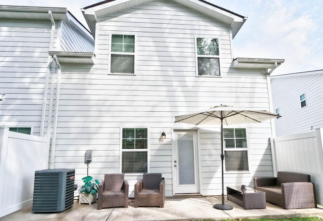 rear view of property with a patio and central AC unit