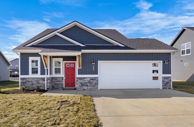 craftsman-style home featuring a front yard and a garage