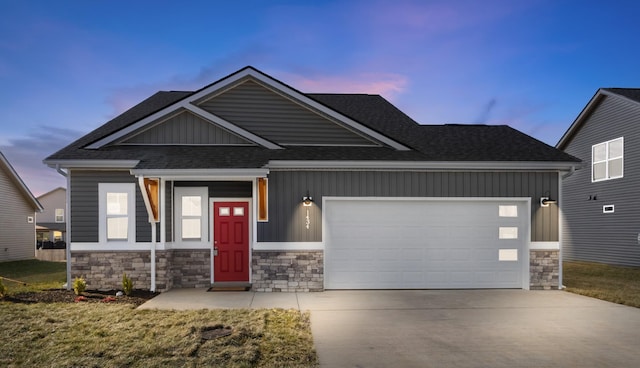 craftsman inspired home featuring a garage and a yard