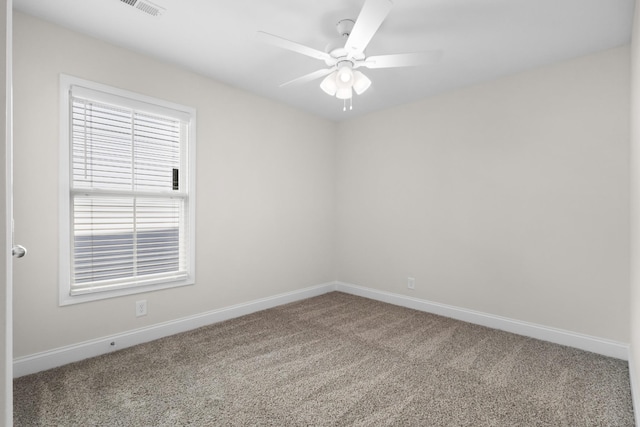 carpeted spare room featuring ceiling fan