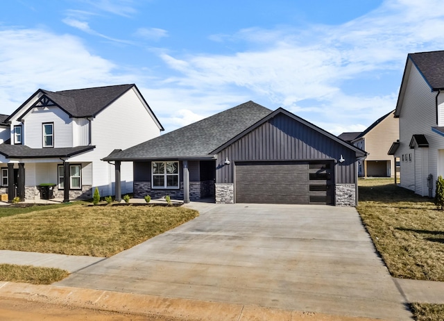 view of front of home with a front yard and a garage