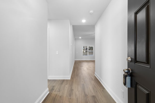 corridor with light hardwood / wood-style floors