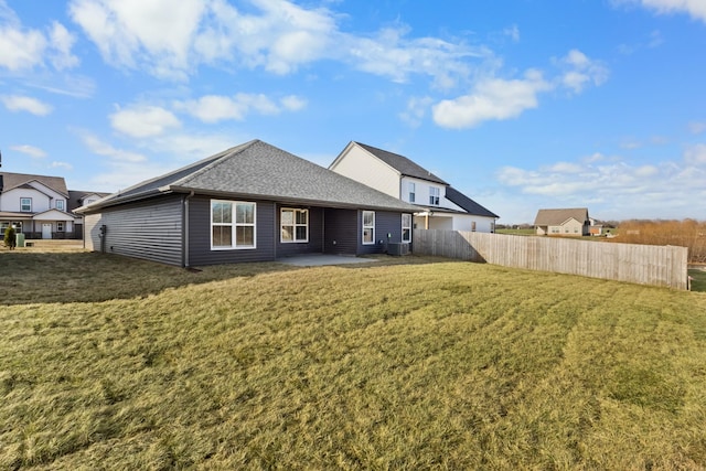 rear view of property featuring a lawn, central air condition unit, and a patio area