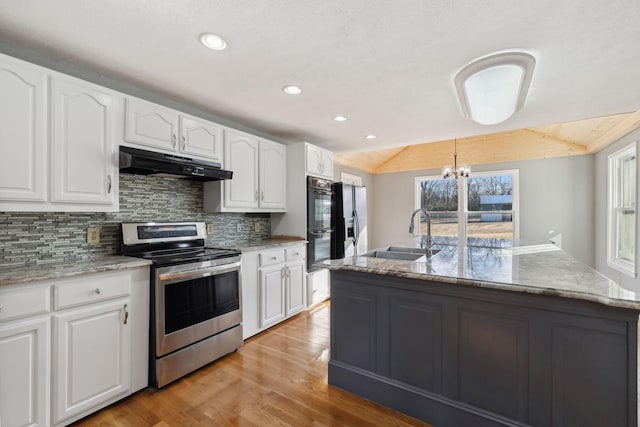 kitchen with white cabinets, a center island with sink, and stainless steel range with electric cooktop