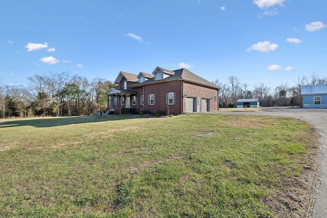 view of side of home with a yard and a garage