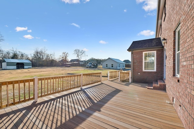 wooden terrace featuring a yard