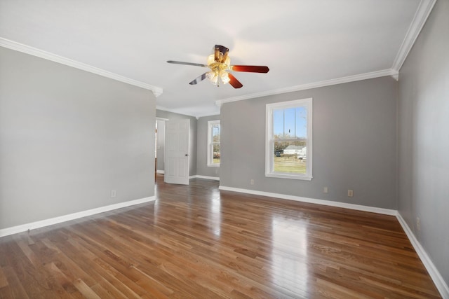 spare room with dark hardwood / wood-style floors, ceiling fan, and crown molding