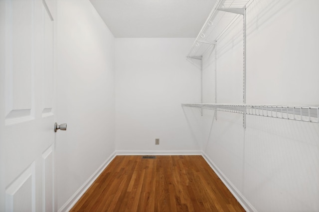 spacious closet featuring hardwood / wood-style floors