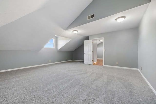 additional living space with carpet flooring and vaulted ceiling