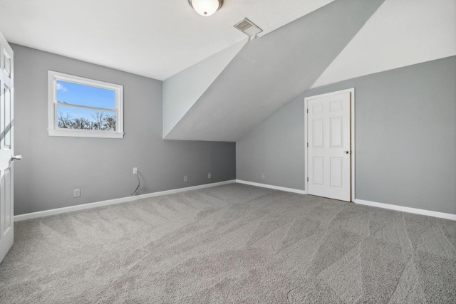 bonus room with carpet and vaulted ceiling