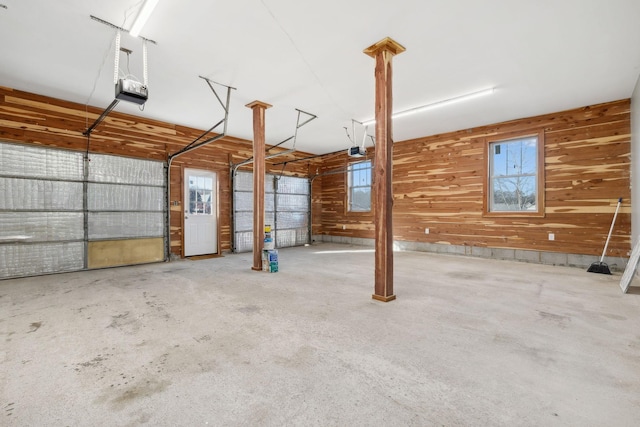 garage featuring wooden walls and a garage door opener