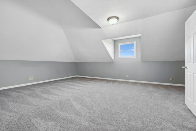 bonus room featuring carpet flooring and lofted ceiling