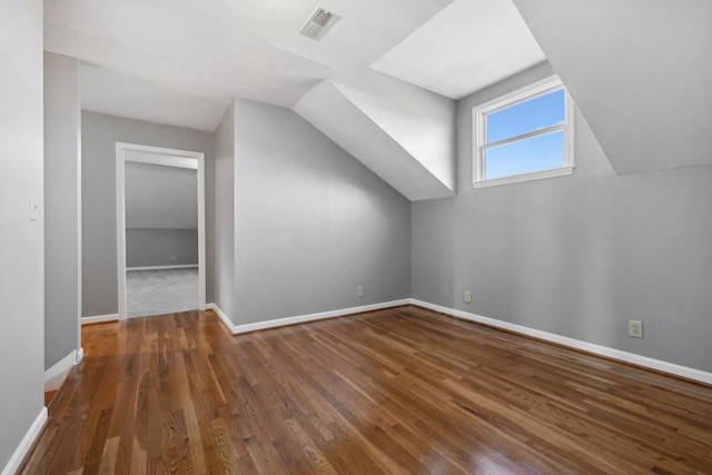 bonus room featuring dark hardwood / wood-style flooring and vaulted ceiling