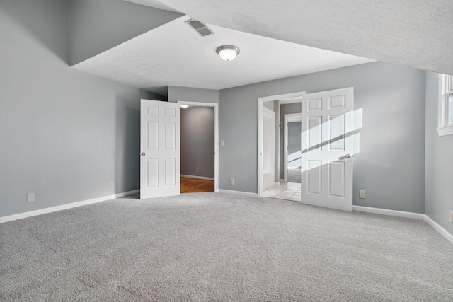 unfurnished room featuring light carpet