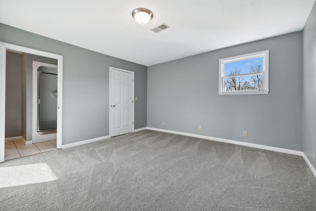 unfurnished bedroom featuring light carpet