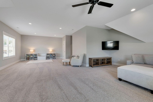 carpeted living room featuring ceiling fan and lofted ceiling