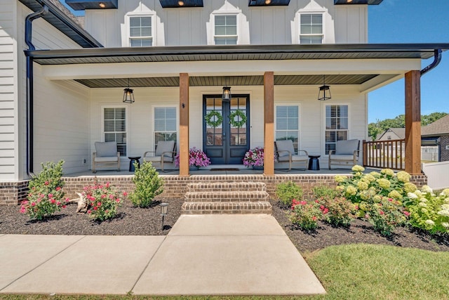 property entrance featuring covered porch and french doors