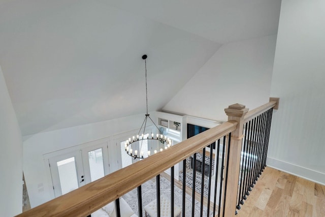 room details featuring french doors, hardwood / wood-style flooring, and a notable chandelier