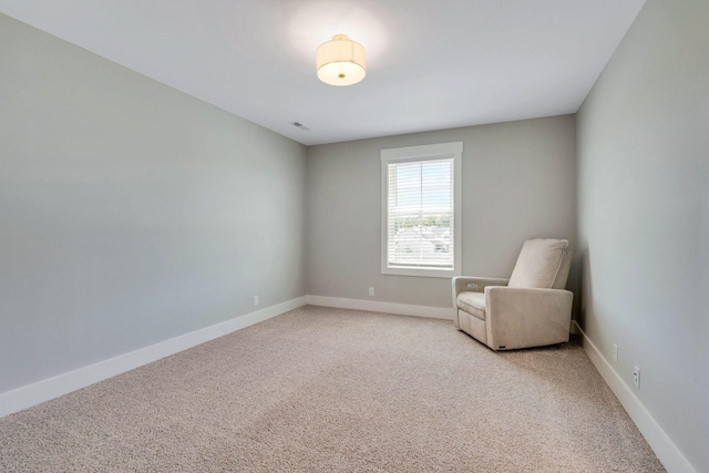 unfurnished room with light colored carpet