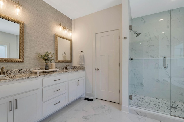 bathroom with a shower with door and vanity