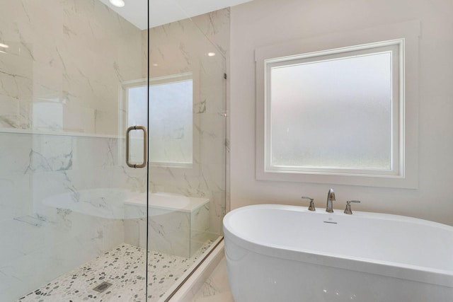 bathroom with separate shower and tub