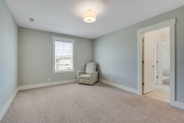 unfurnished room featuring light colored carpet