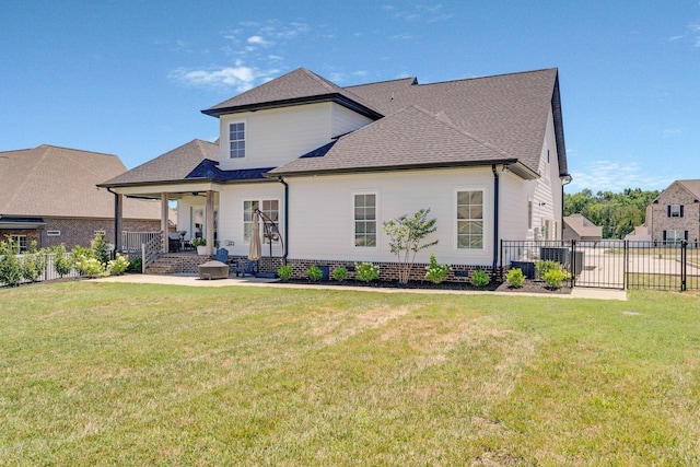 back of property featuring a yard and ceiling fan