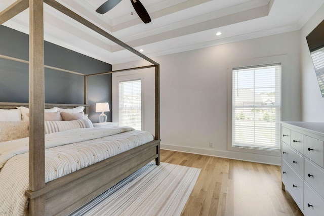 bedroom featuring multiple windows, light hardwood / wood-style flooring, and ceiling fan