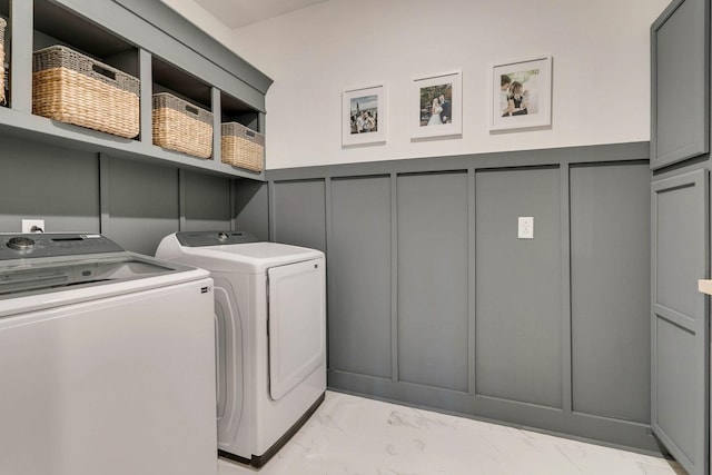 laundry area featuring cabinets and washing machine and dryer