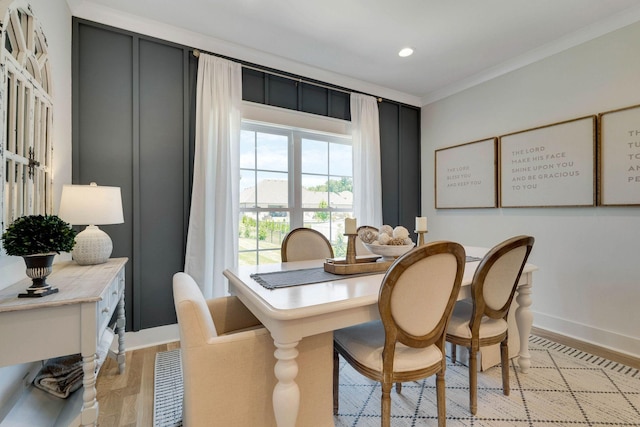 dining room with light hardwood / wood-style floors and ornamental molding