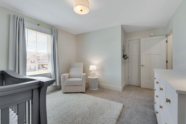 carpeted bedroom featuring a crib