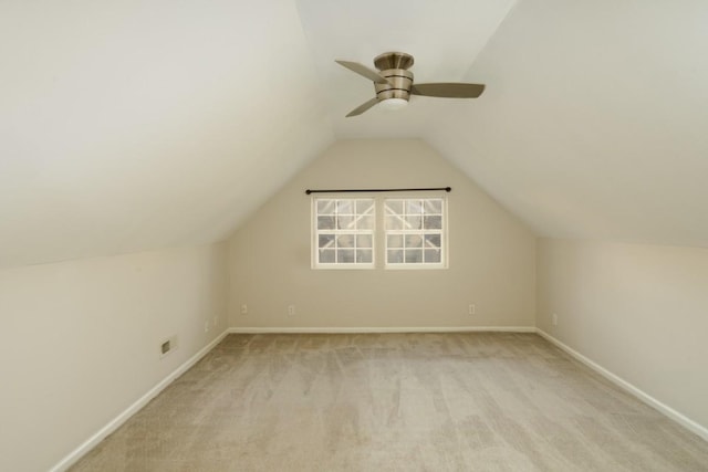 bonus room with ceiling fan, light colored carpet, and vaulted ceiling