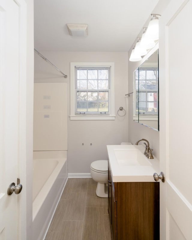 full bathroom with vanity, tub / shower combination, and toilet