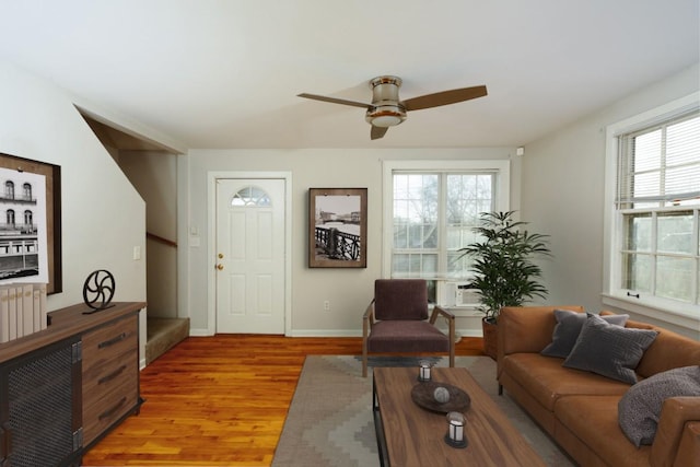 living room with ceiling fan and light hardwood / wood-style floors