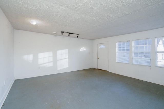 unfurnished room with a textured ceiling