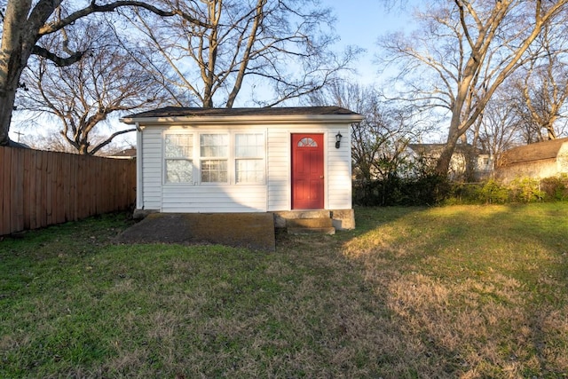 view of outbuilding featuring a lawn