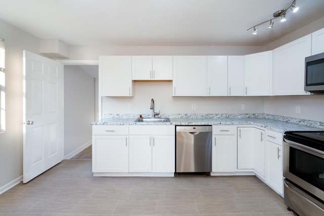 kitchen featuring white cabinets, light stone counters, sink, and stainless steel appliances