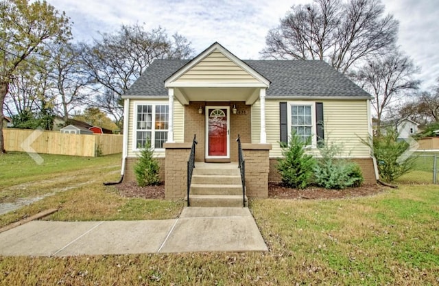 bungalow-style house with a front yard